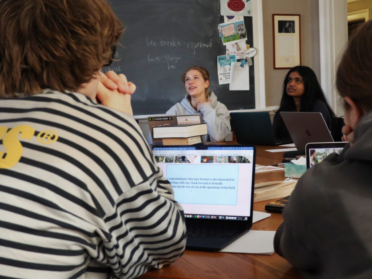 students sitting on a harkness table