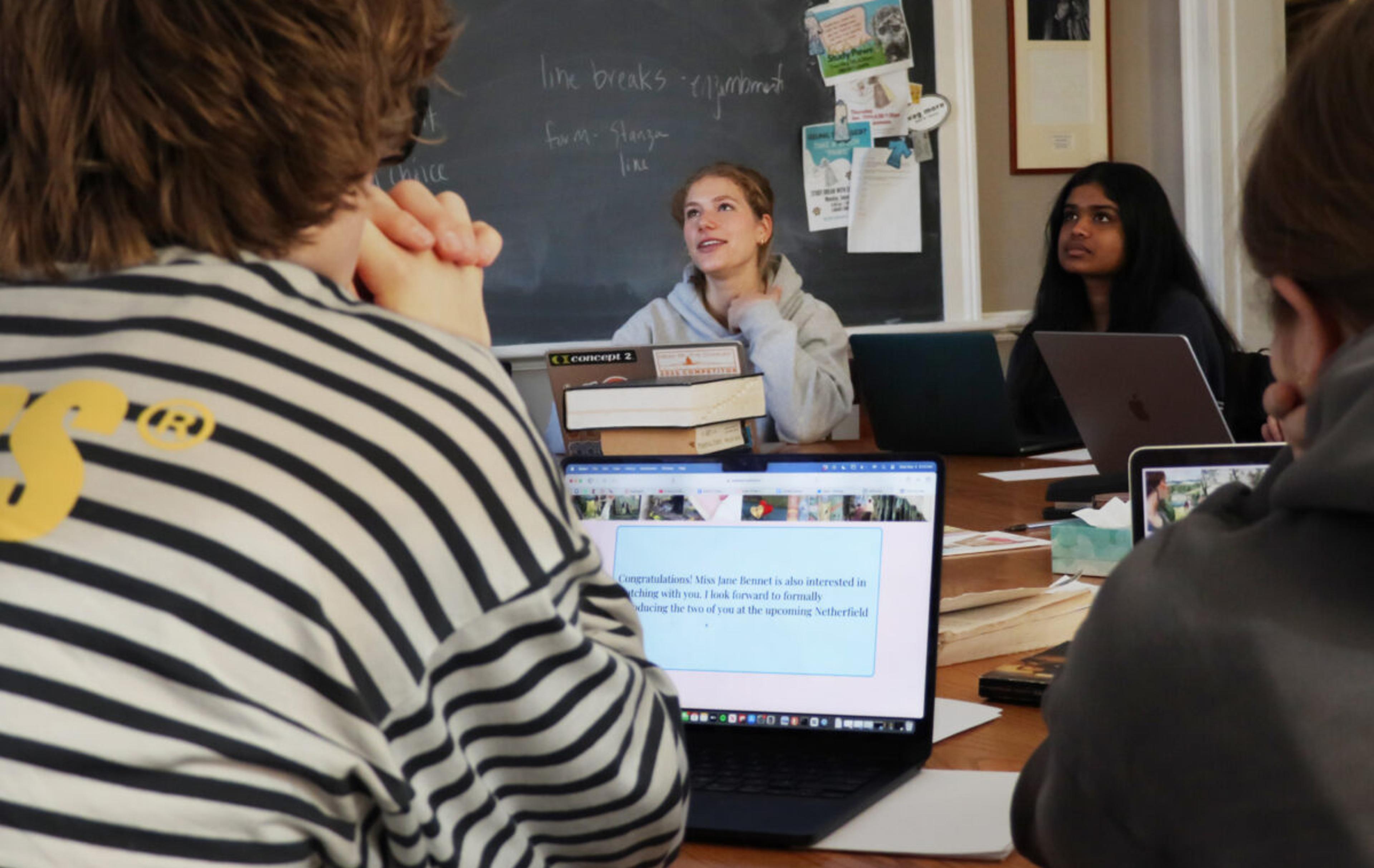 students sitting on a harkness table