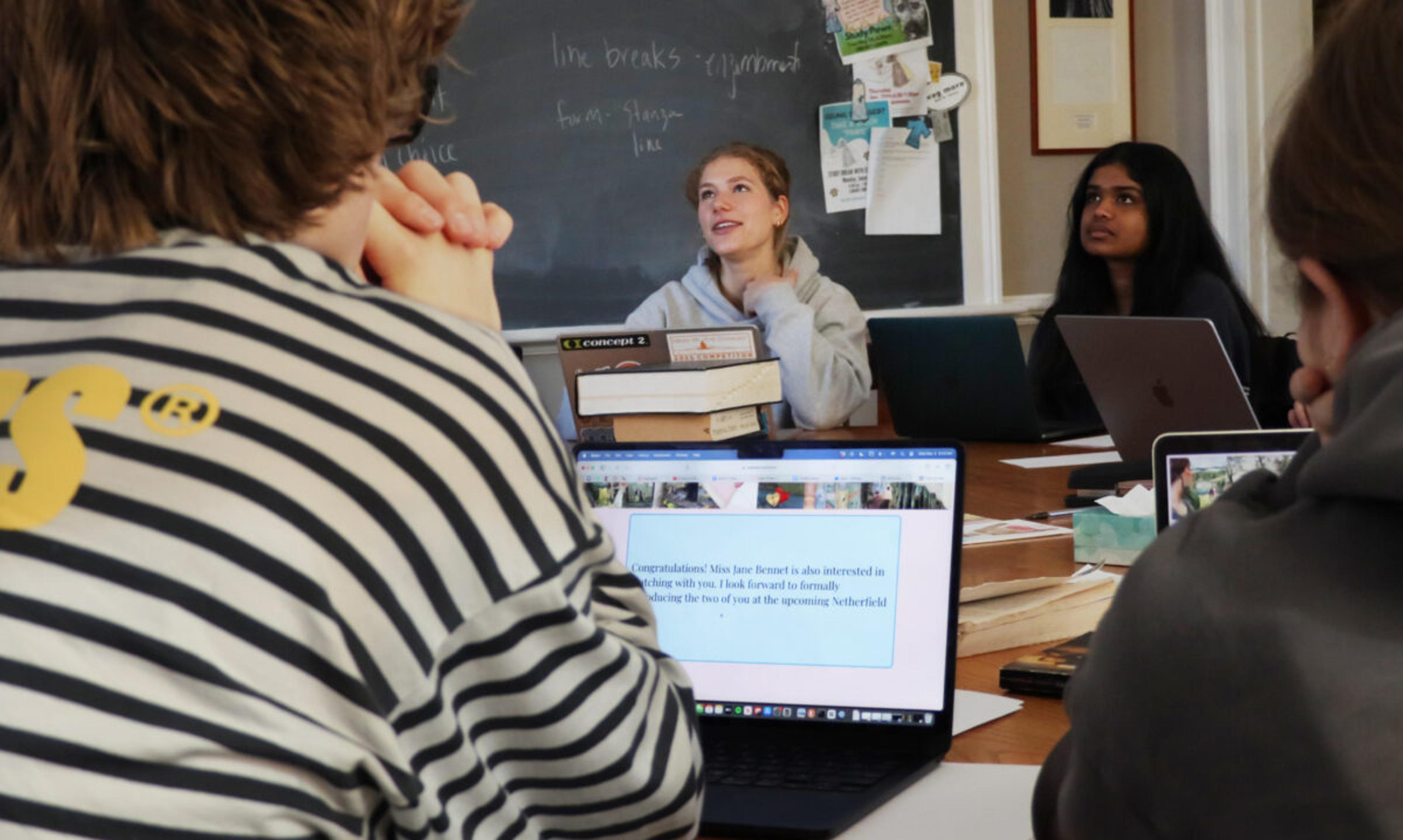 students sitting on a harkness table