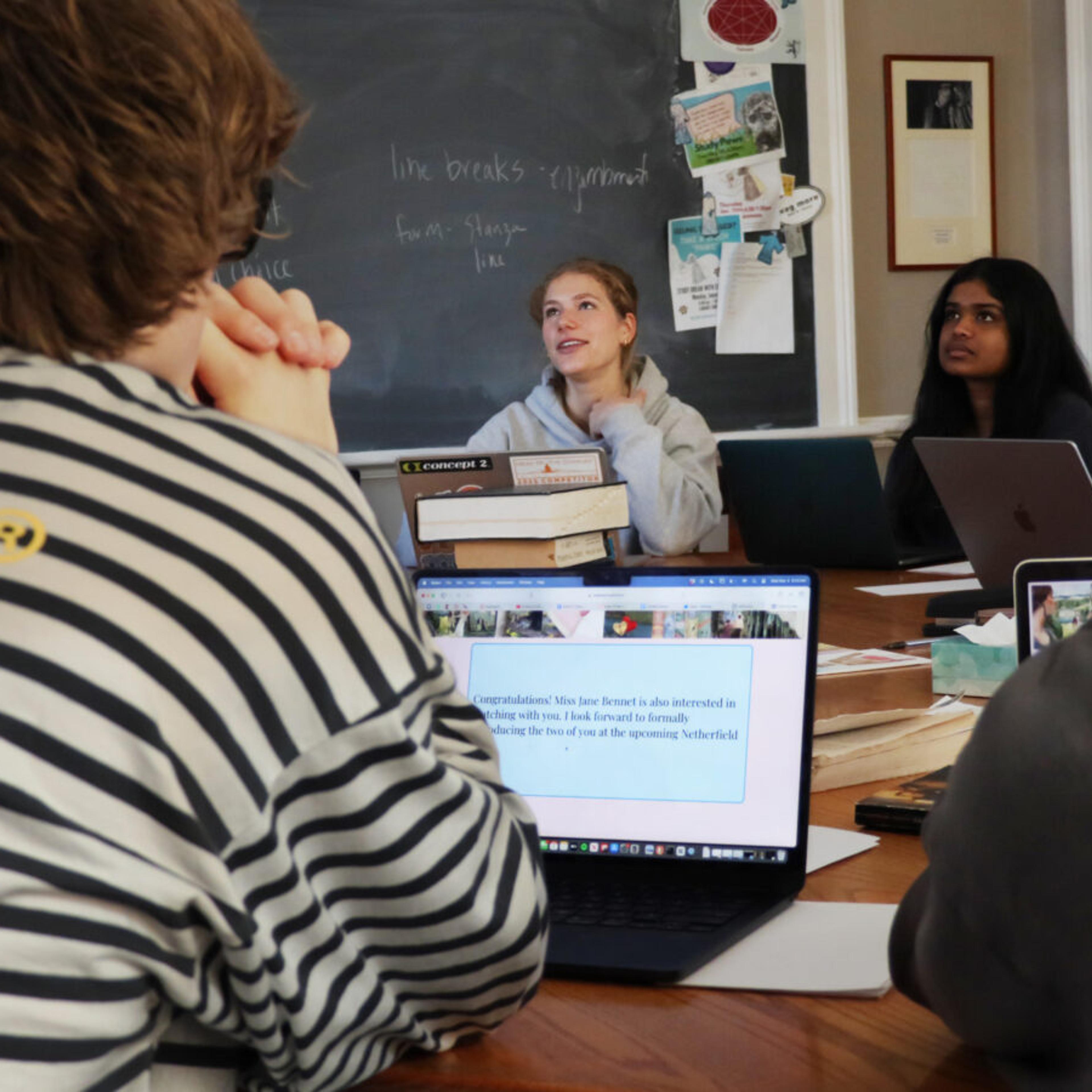 students sitting on a harkness table