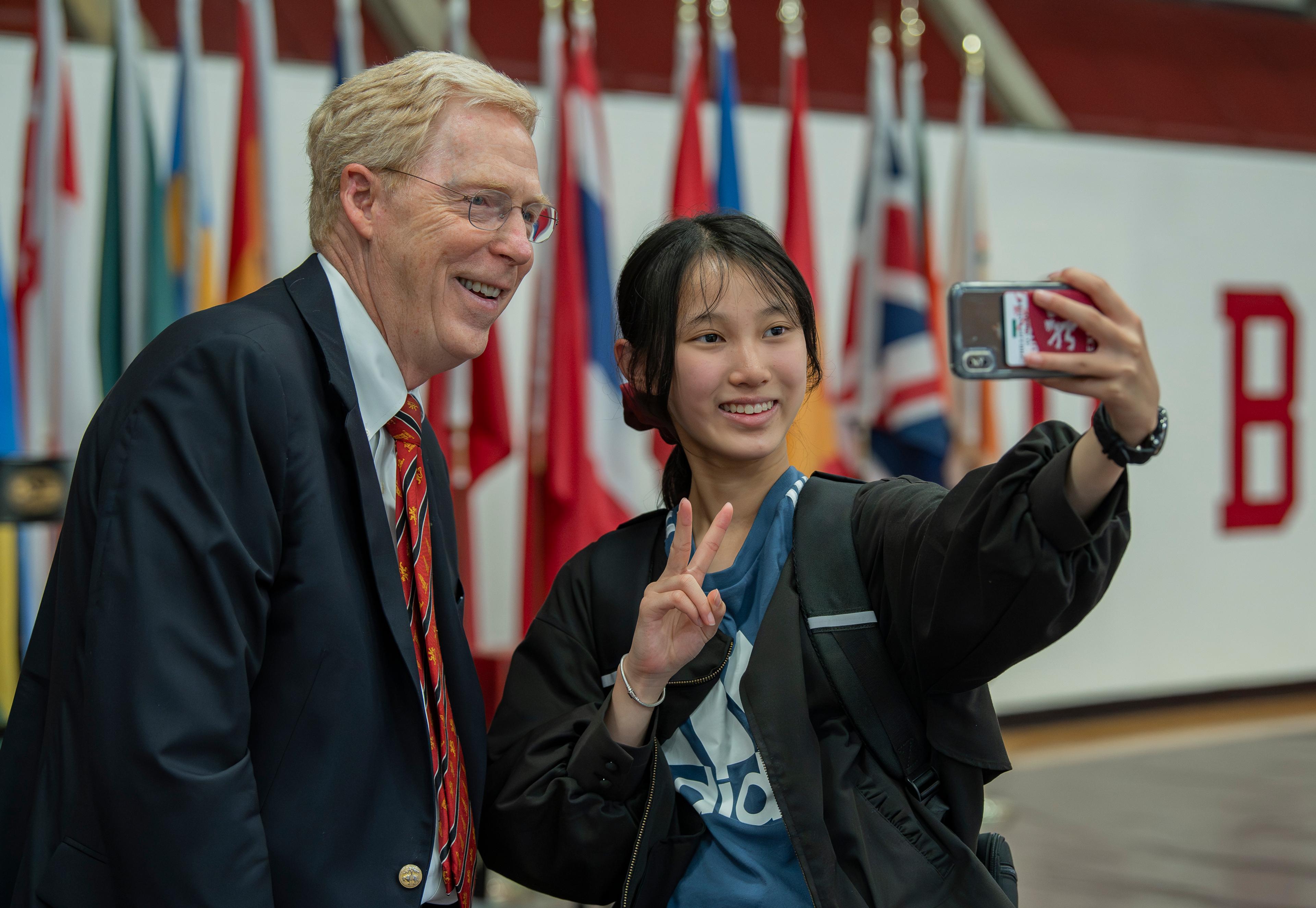 Principal Rawson takes selfie with a student at assembly