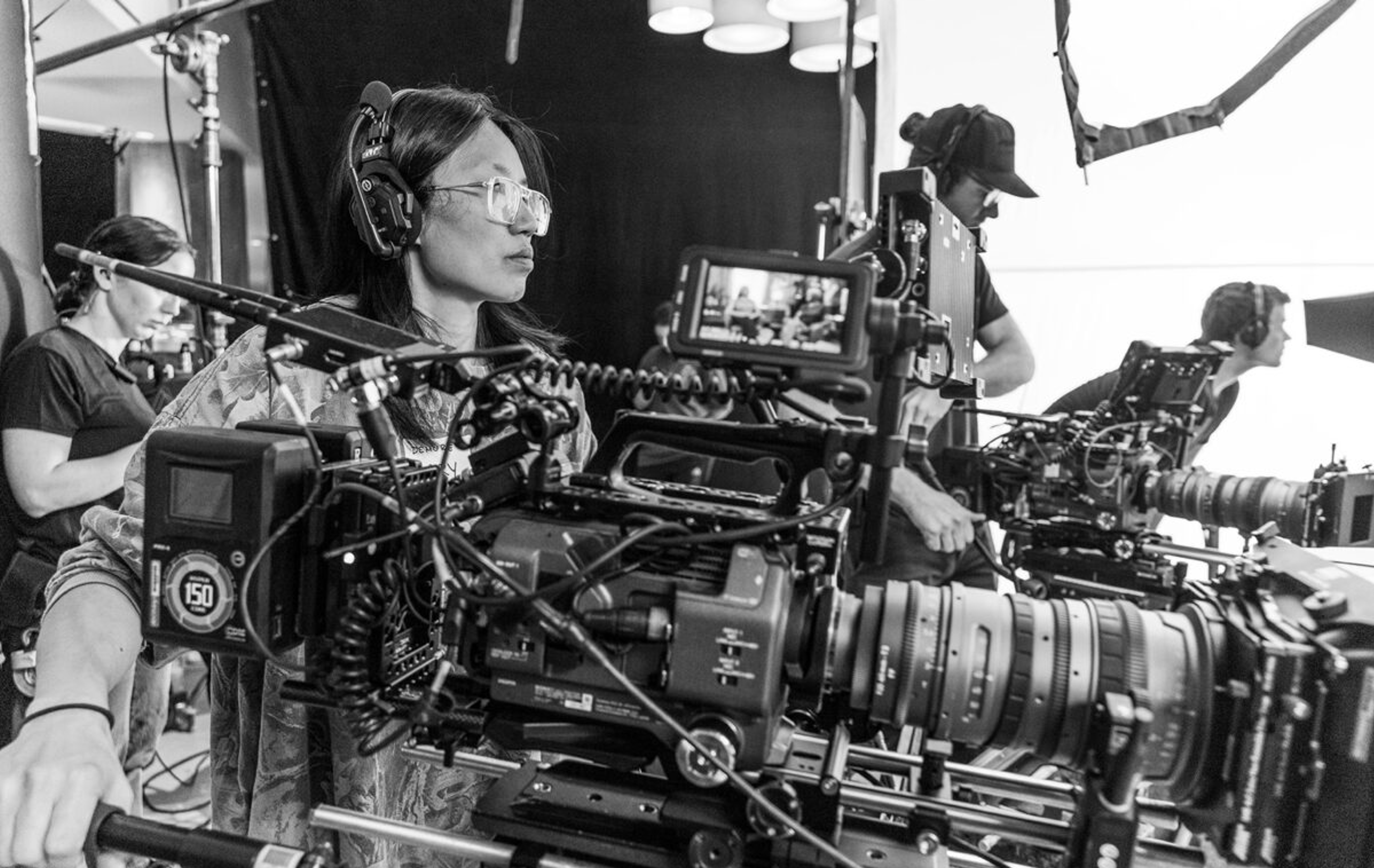 Woman stands with movie camera directing a shot