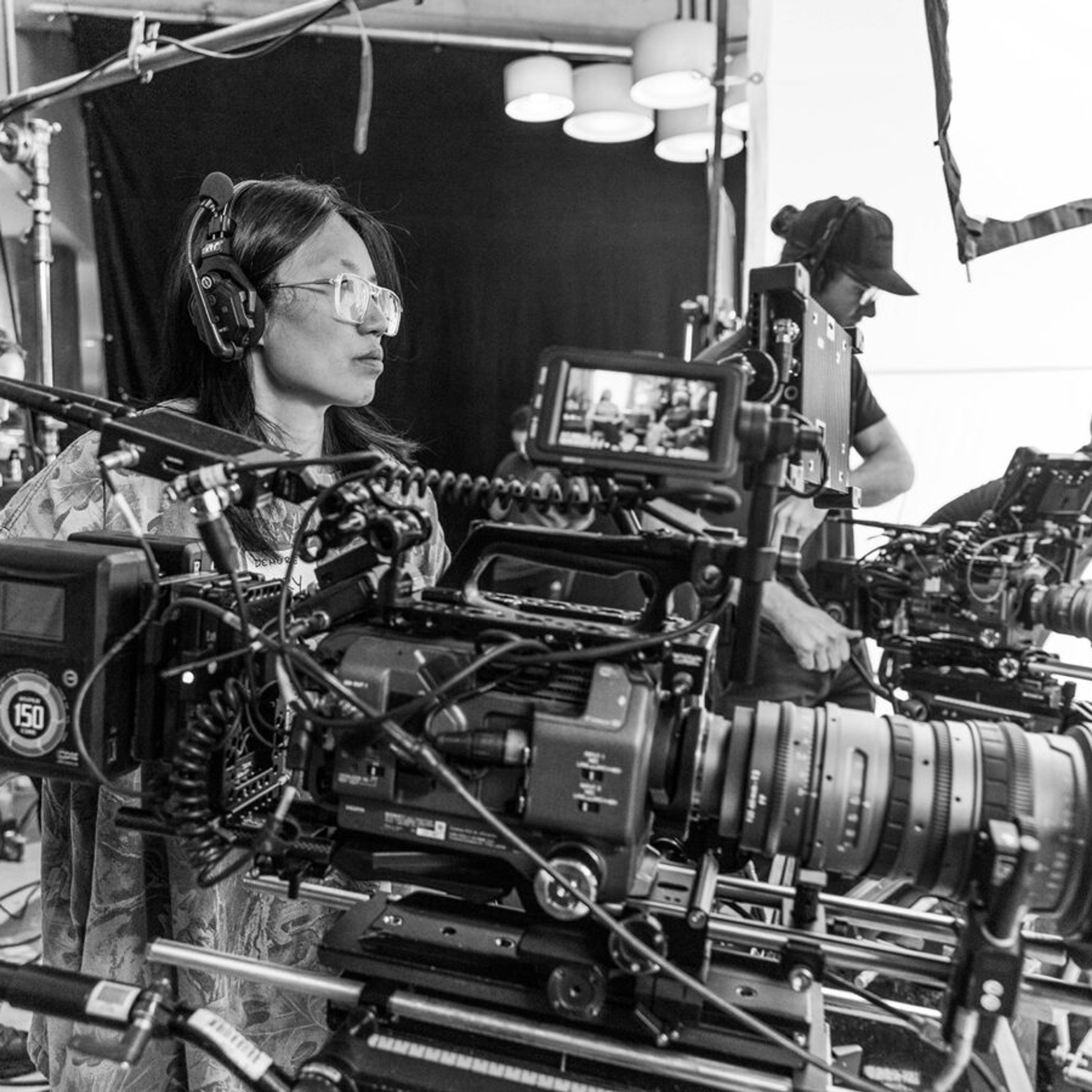 Woman stands with movie camera directing a shot