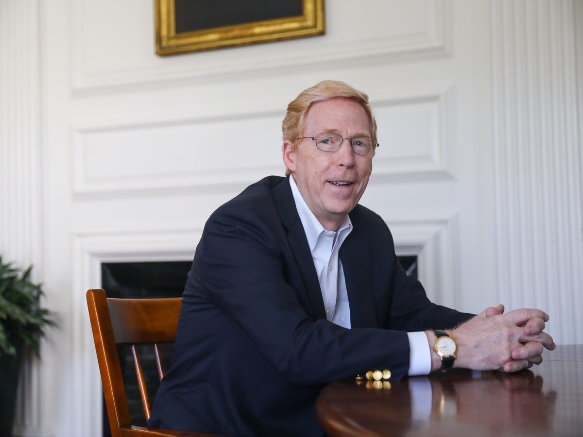 Principal Rawson sits at a wooden table