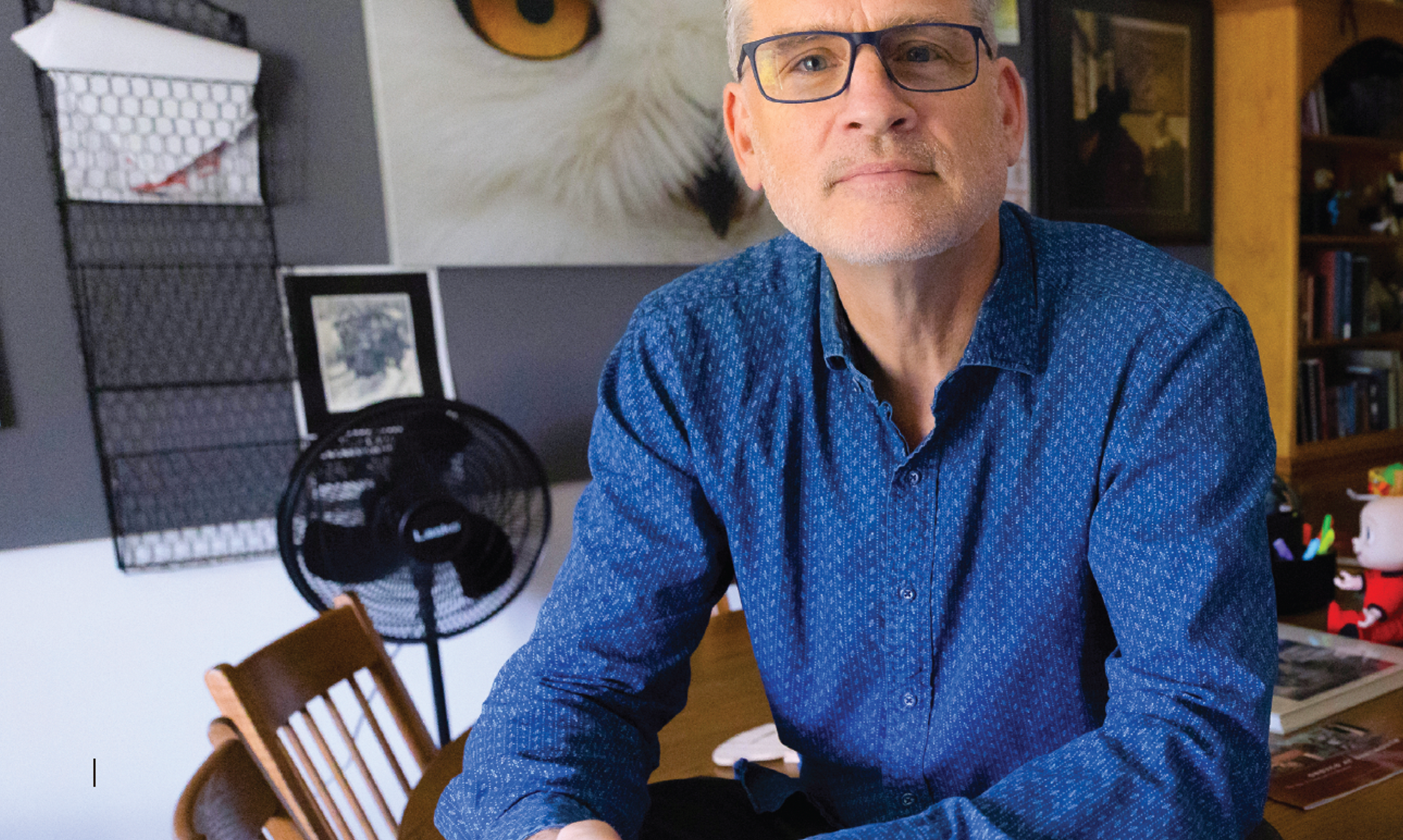 Man with glasses and blue shirt.