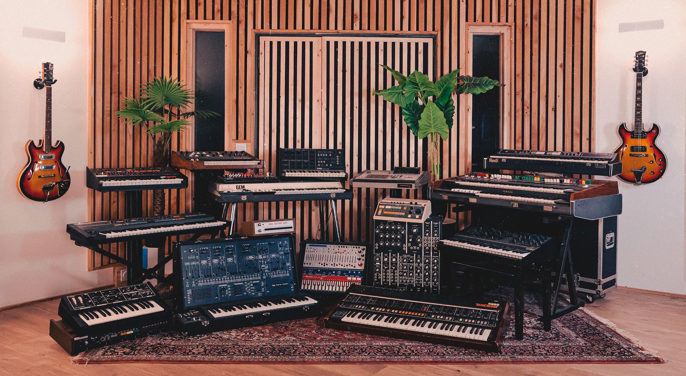 The synthesizer room — walls of vintage keyboards and guitars