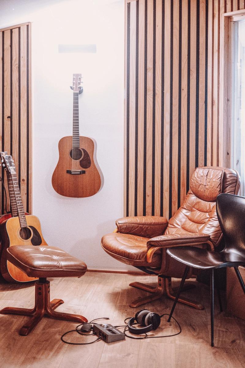 Acoustic guitar and leather chairs