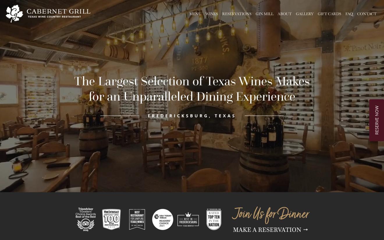 Cabernet Grill restaurant interior in Fredericksburg, Texas with rustic dining tables and wine wall displays