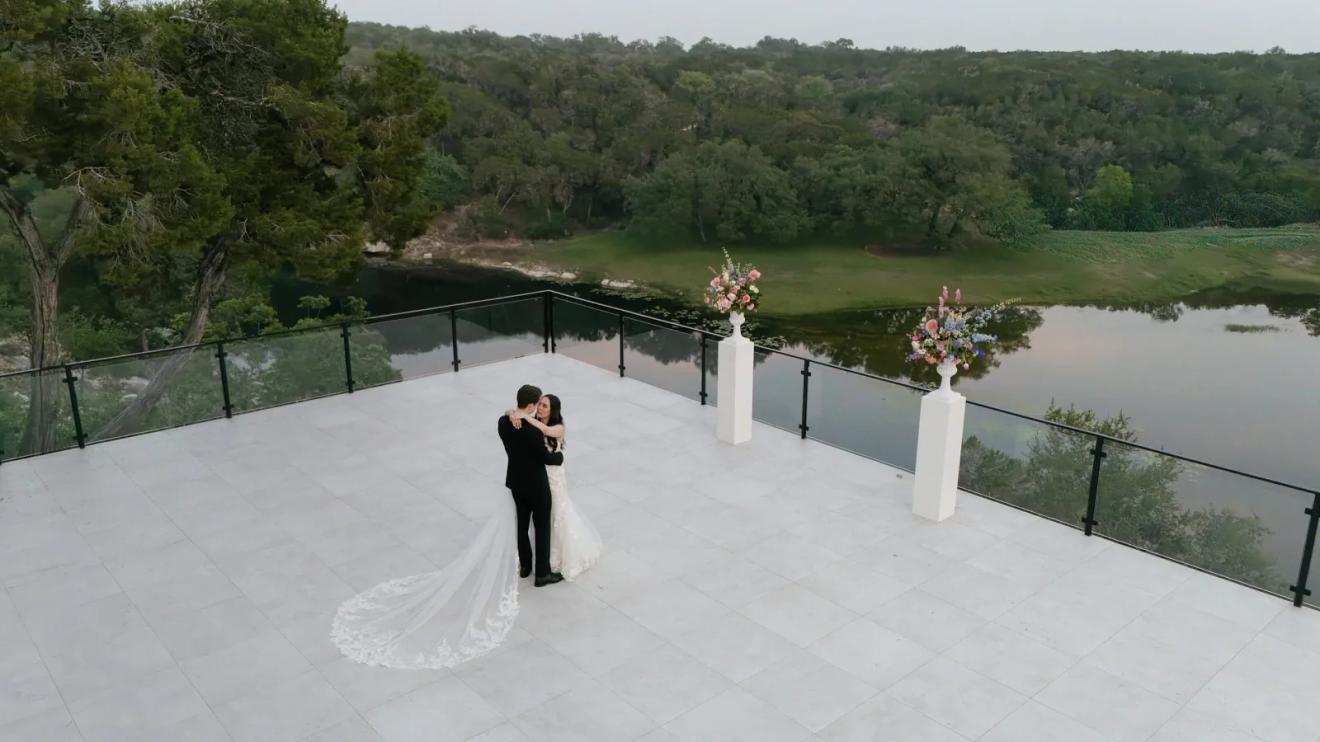 Hilltop ceremony terrace overlooking the lake and wooded valley at The Videre Estate, a Wimberley wedding venue in the Texas Hill Country