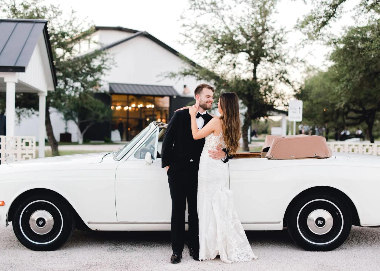 White barn venue and oak-shaded drive at Mae's Ridge, a Johnson City, Texas wedding venue