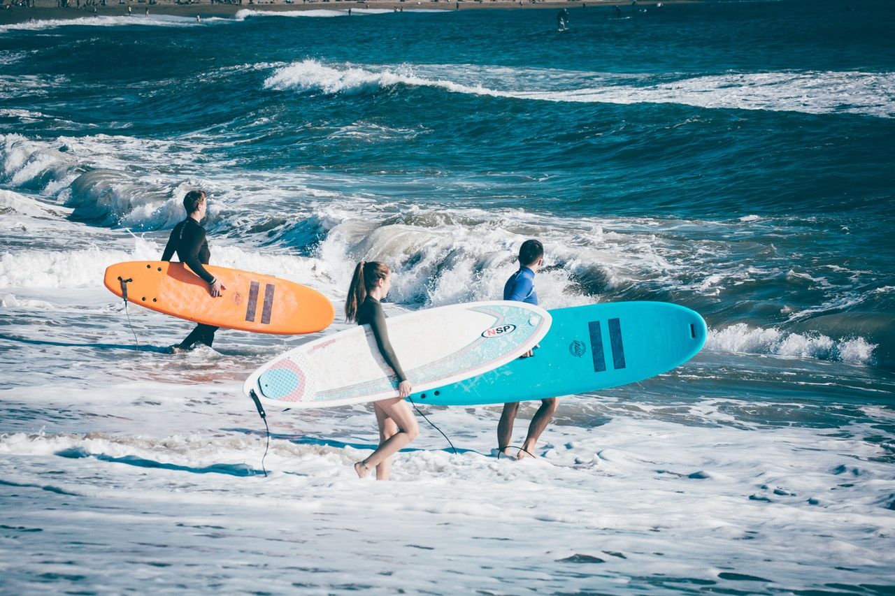 Three person about to surf