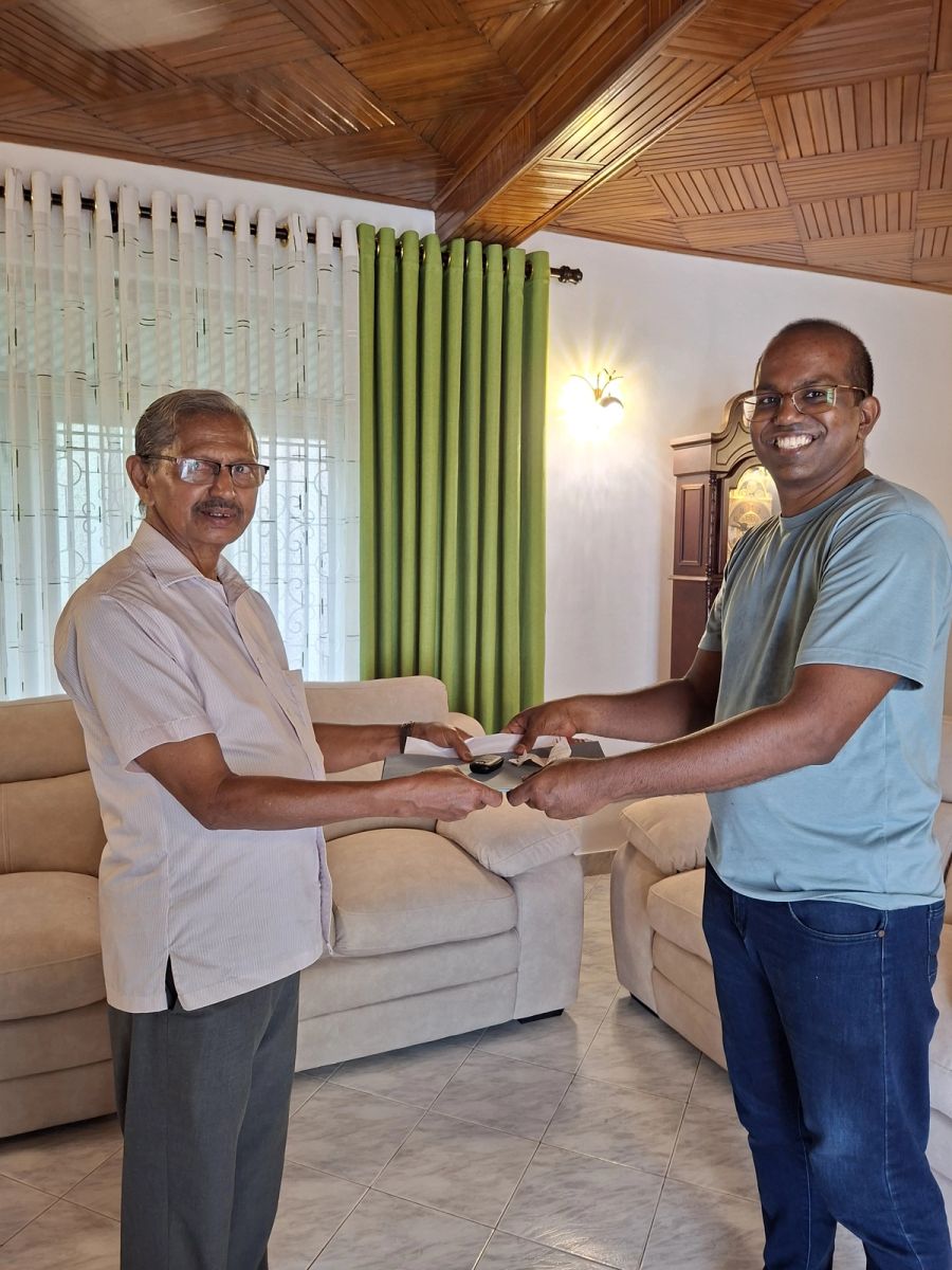 Sandun handing over the keys to a customer