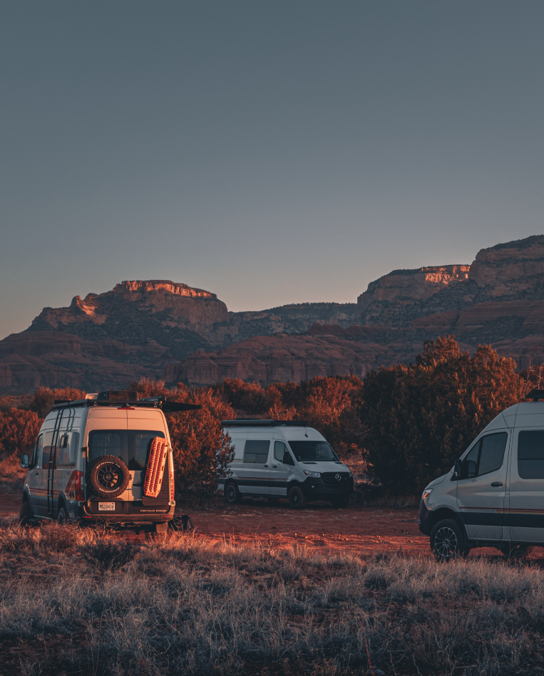 Storyteller Overland vans parked in a canyon