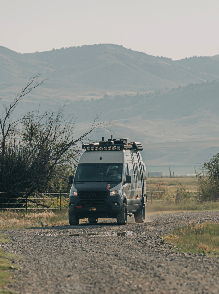 Storyteller van driving on a gravel road