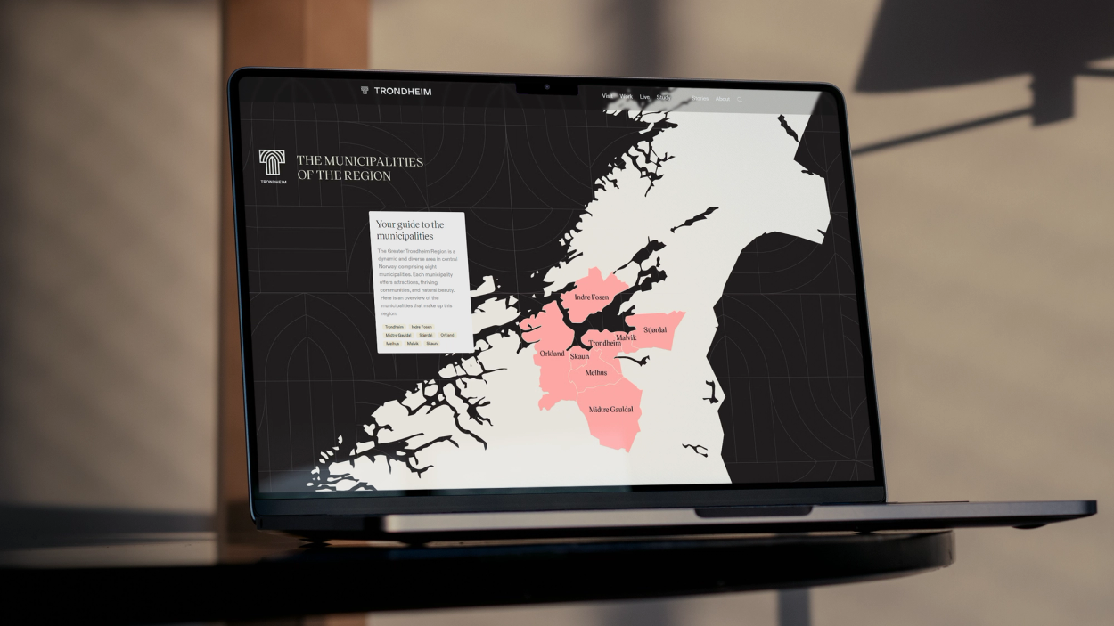 Laptop displaying the Trondheim.com website designed and developed by Nonspace, showing an interactive map of the Greater Trondheim Region with highlighted municipalities.