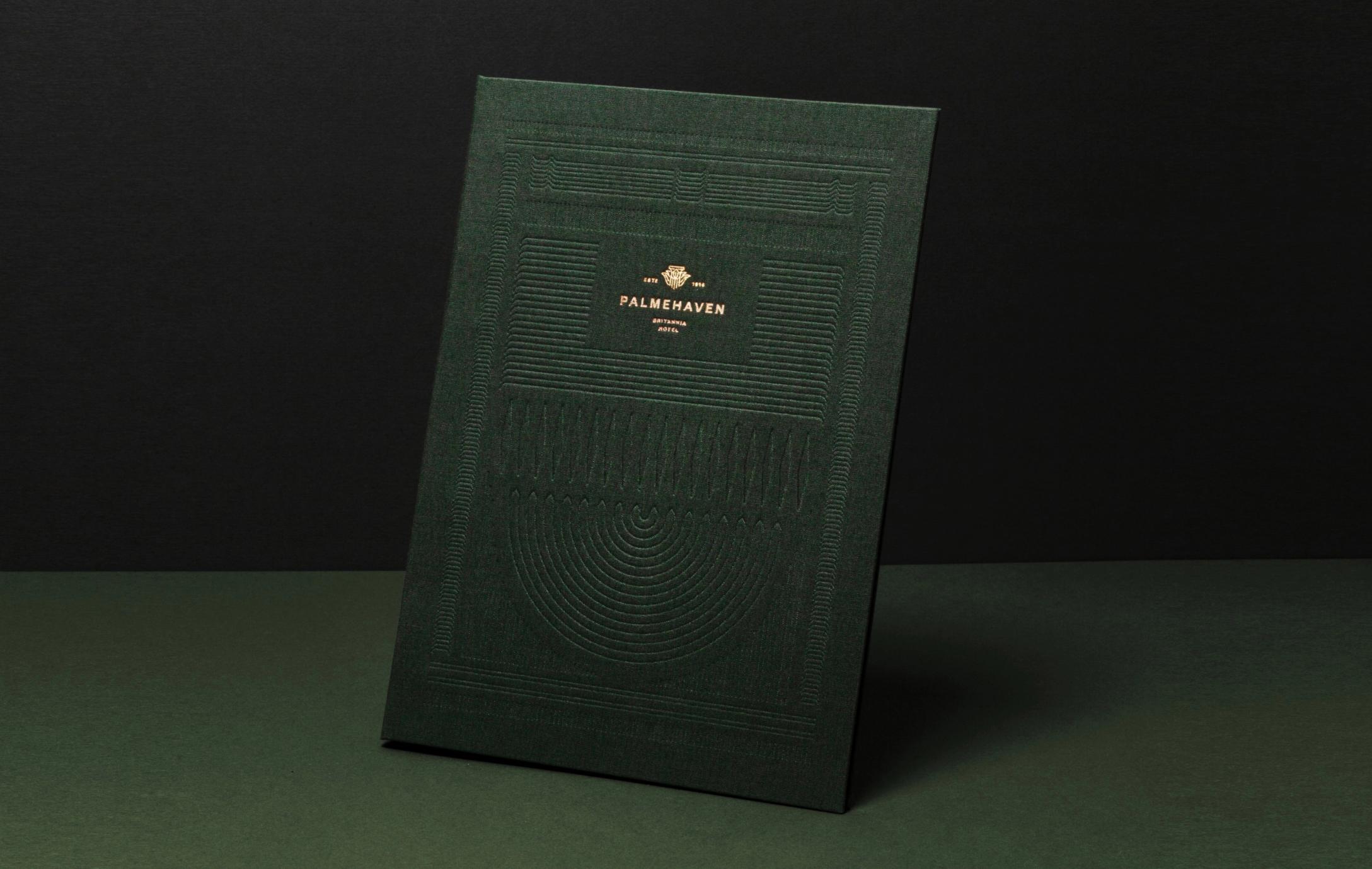 A dark green embossed menu or booklet for Palmehaven at Britannia Hotel with gold foil logo — by Nonspace