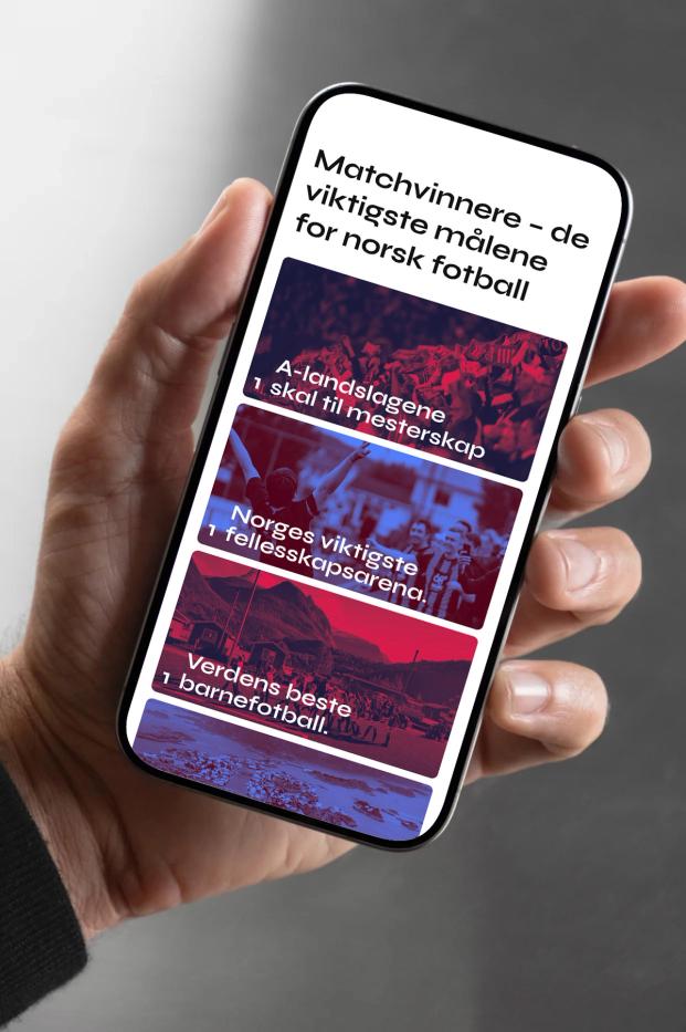 A hand holding a smartphone displaying Norwegian football strategy goals with red and blue imagery — by Nonspace