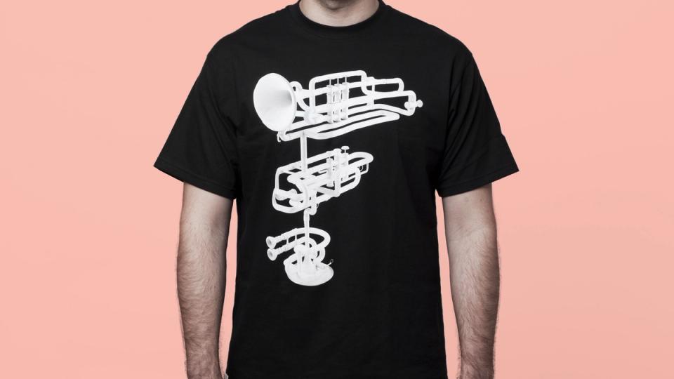 A black t-shirt featuring a white deconstructed trumpet illustration arranged vertically — by Nonspace