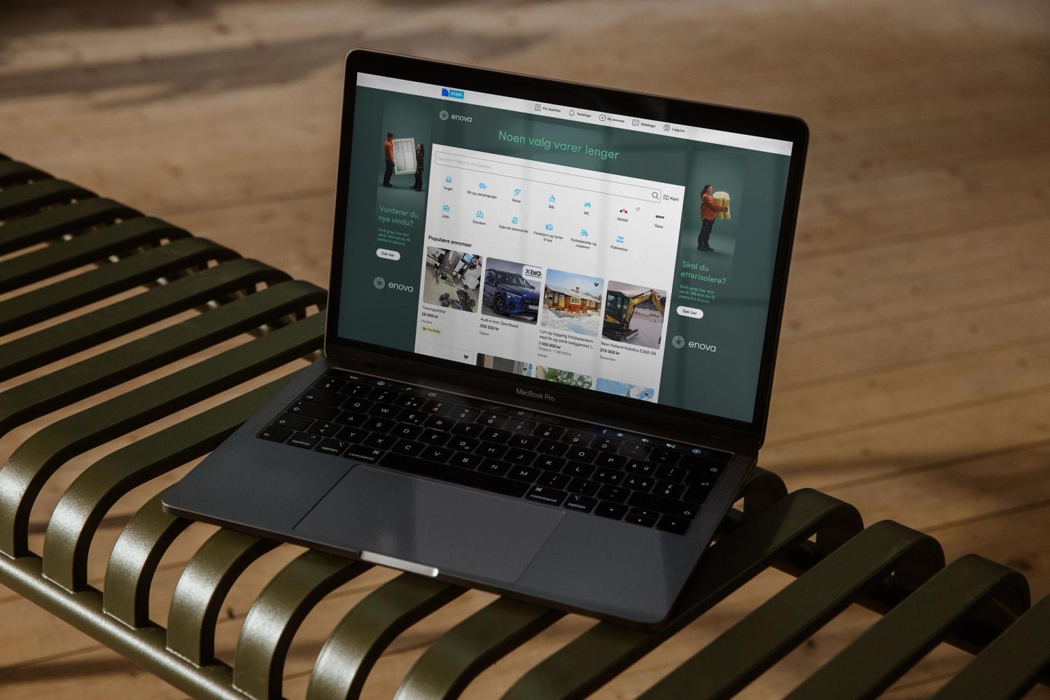 En MacBook Pro på en grønn benk viser Finn.no med Enova-annonser om vinduer og etterisolering — av Nonspace