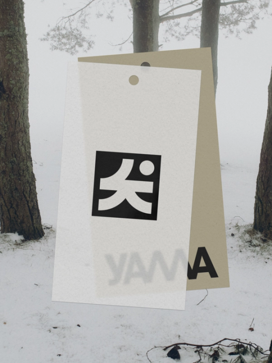Two hanging tags featuring the Yama logo displayed against a snowy winter forest backdrop — by Nonspace