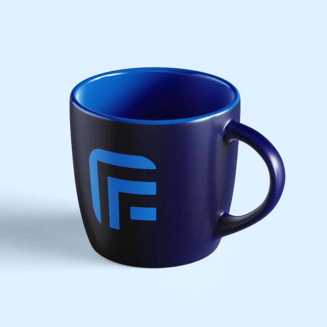A dark blue coffee mug with a bright blue geometric logo on a light blue background — by Nonspace