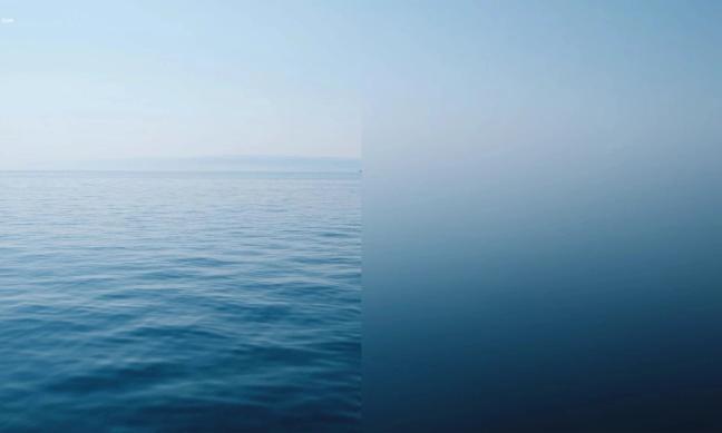 Et rolig hav møter en disig himmel, der halvparten av bildet viser bølger og den andre en jevn gradient — av Nonspace