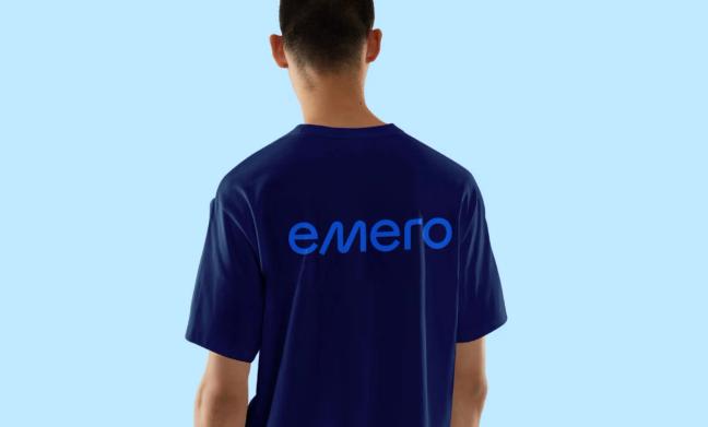 A man seen from behind wearing a dark blue t-shirt with the Emero logo printed on the back — by Nonspace