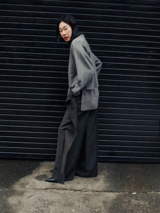 Woman in dark sweater in an urban setting