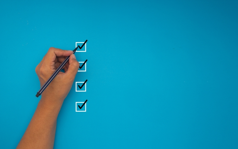 Image Hand checking boxes on a checklist illustrating steps to prepare for a New Jersey expungement in 2026