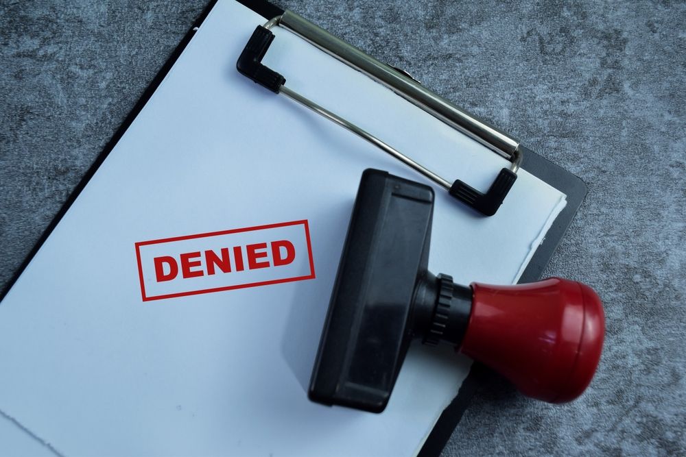 Denied expungement document on clipboard with red stamp showing rejection in New Jersey legal process