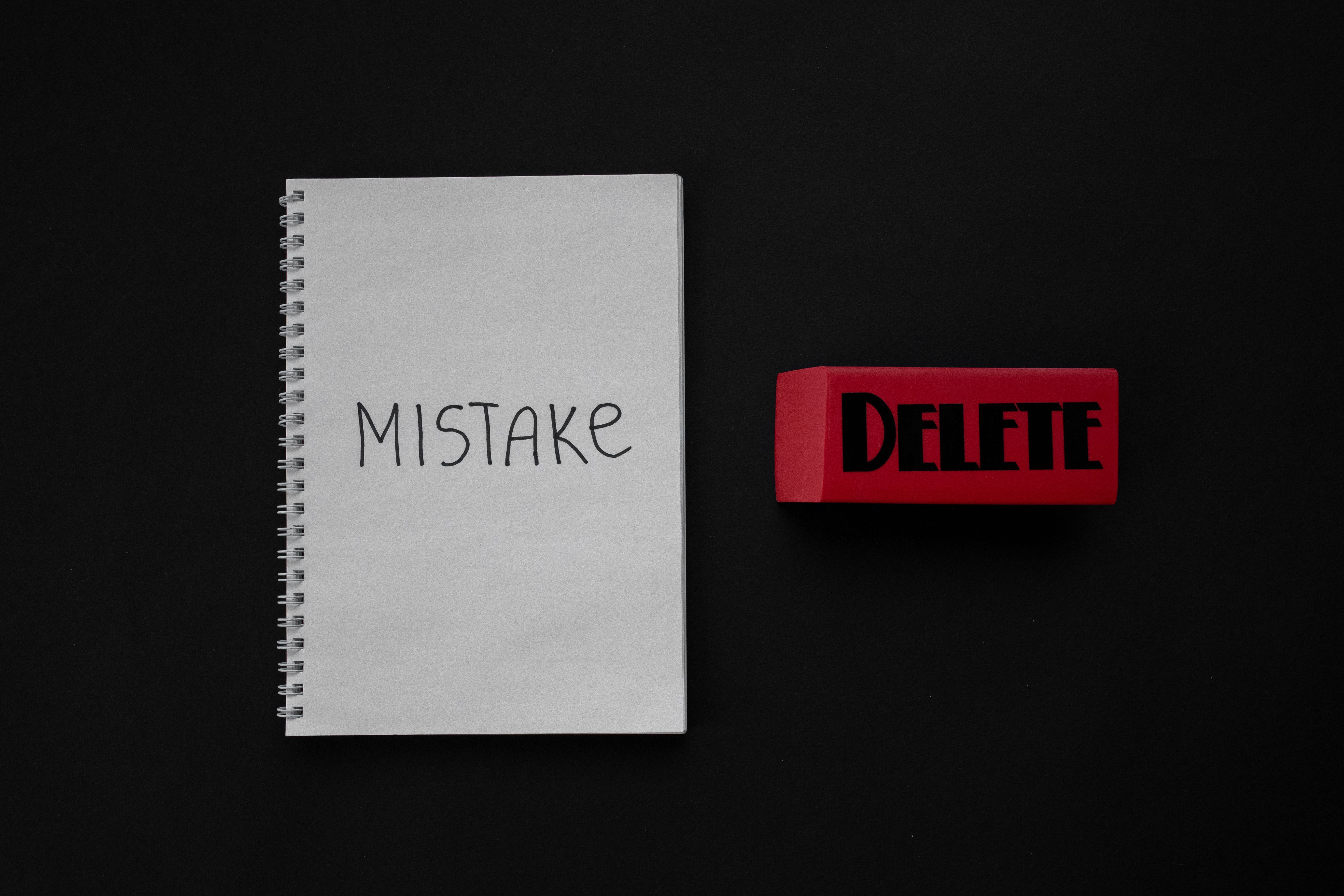Notebook reading MISTAKE beside a red DELETE eraser, representing common New Jersey expungement filing mistakes.