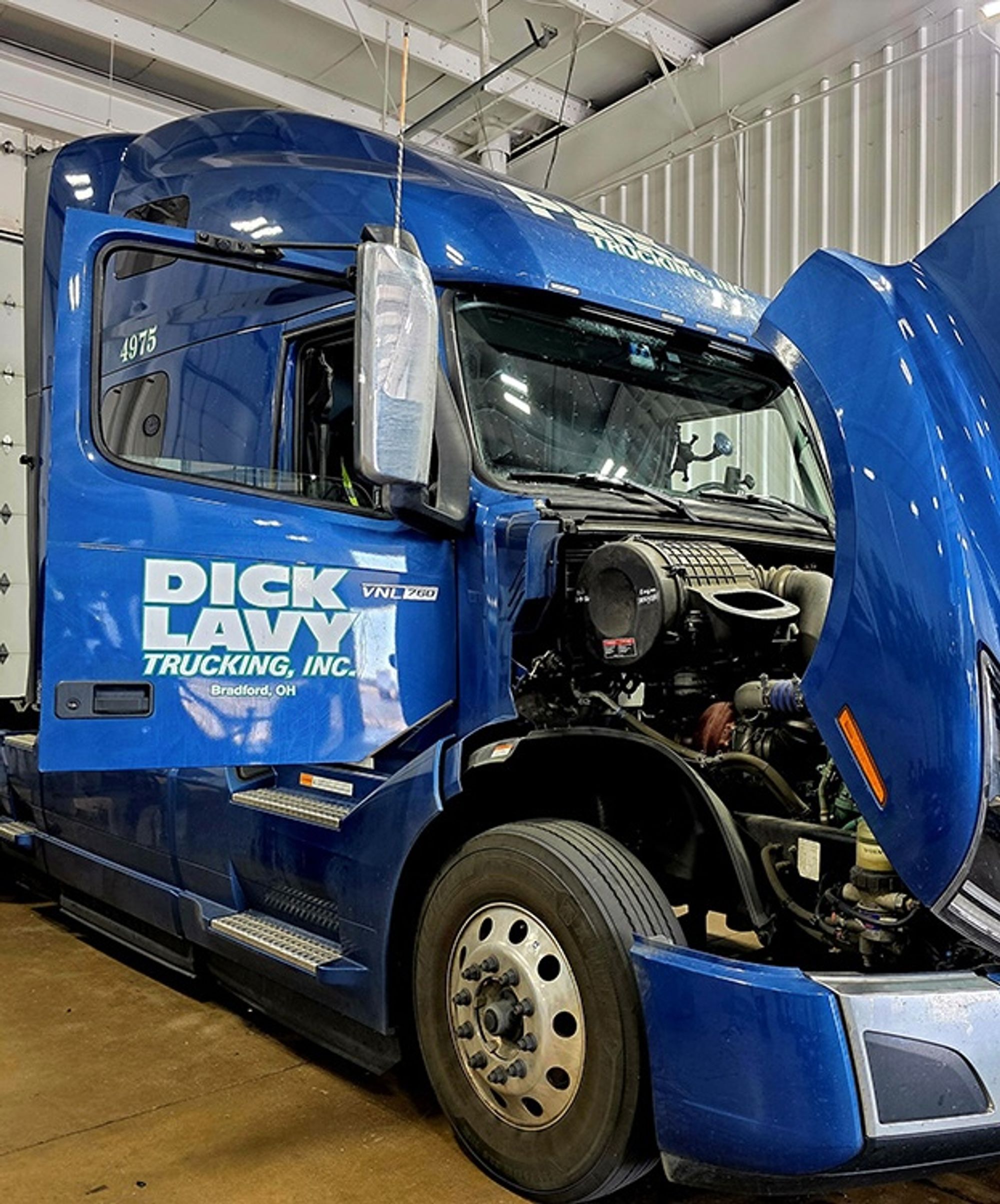 Dick Lavy Trucking tractor with hood open for service in the Bradford, Ohio shop