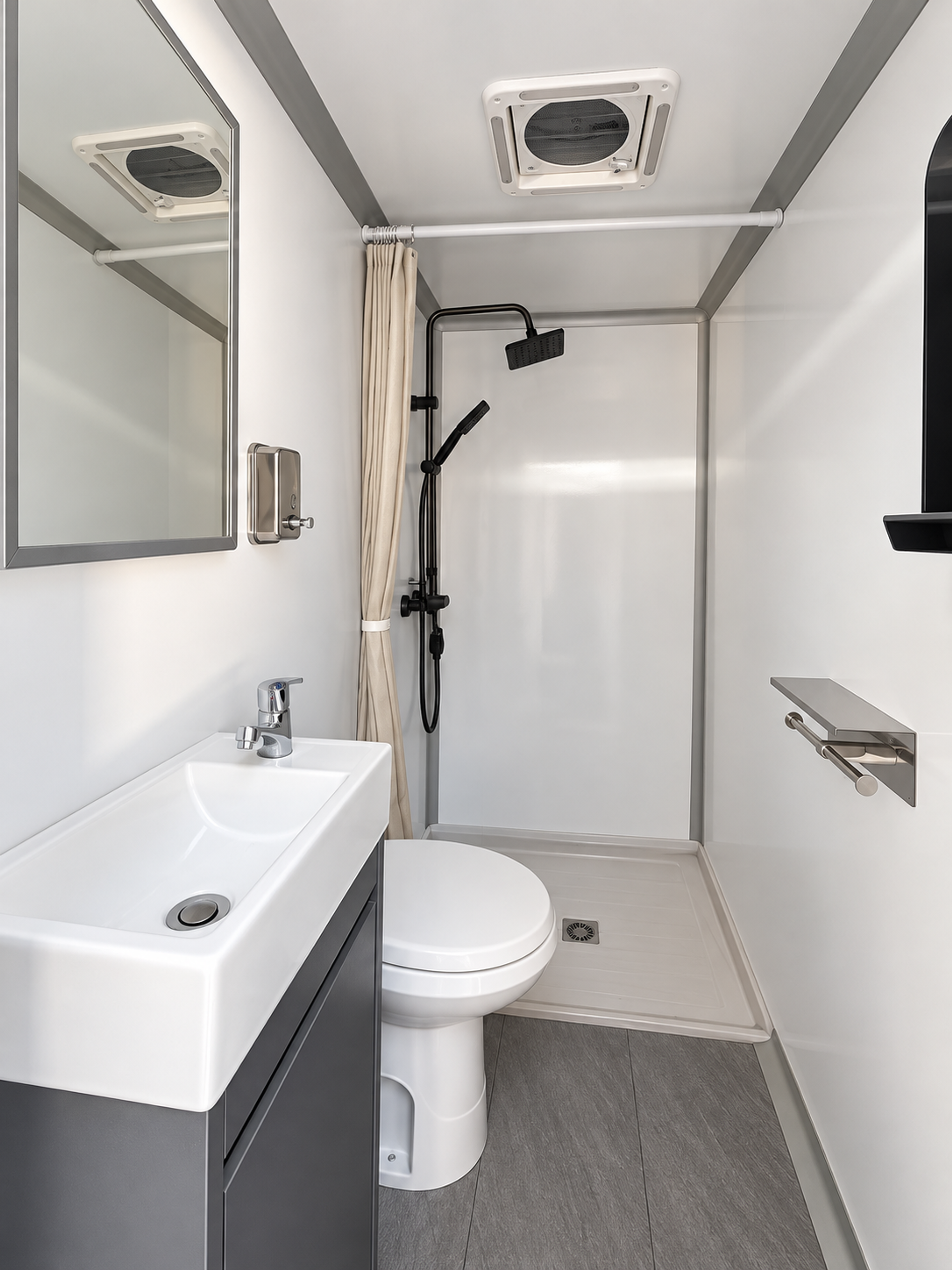 Shower suite interior with in-stall shower, toilet, vanity sink and roof vent