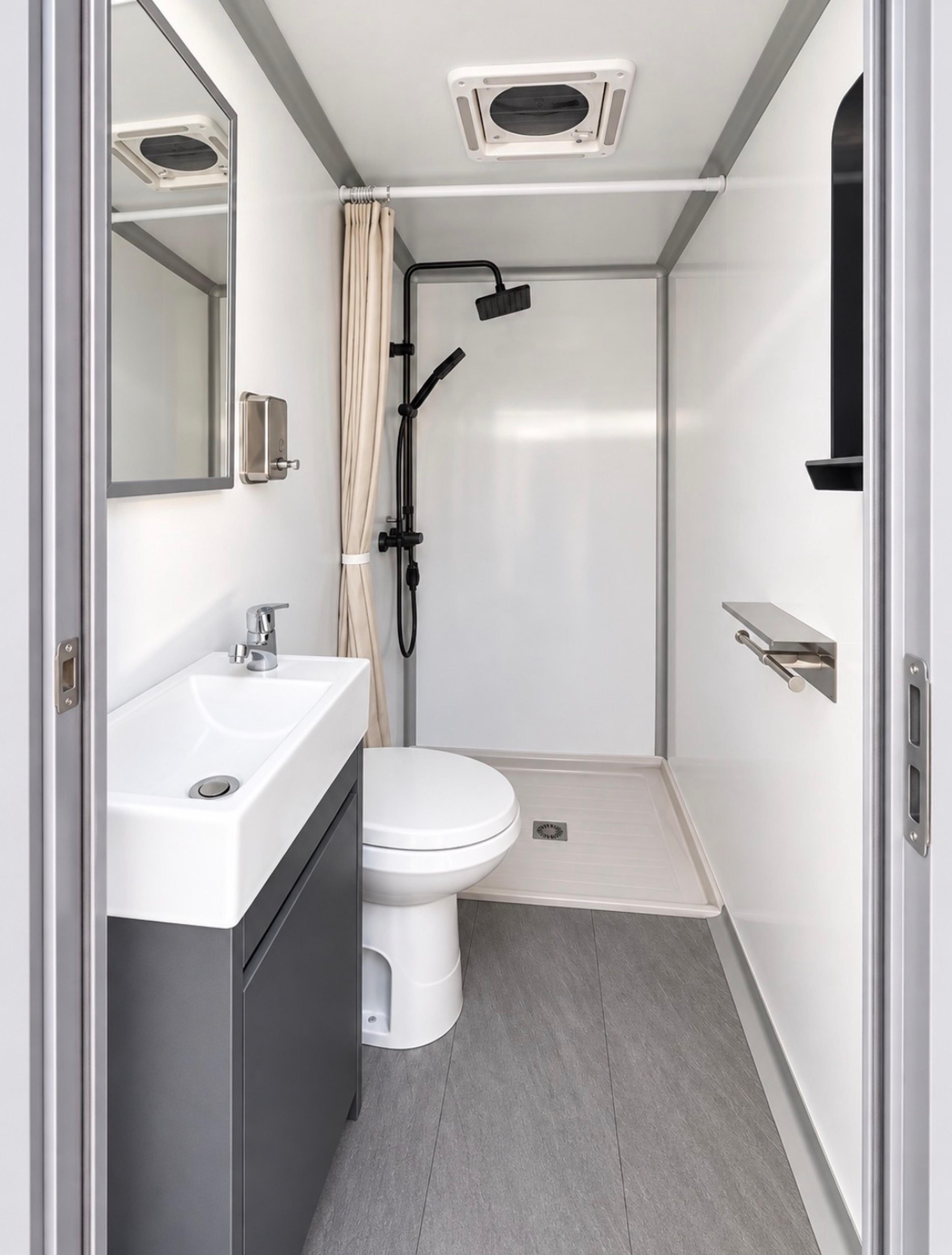 2-Stall + Shower stall interior with shower, toilet and sink