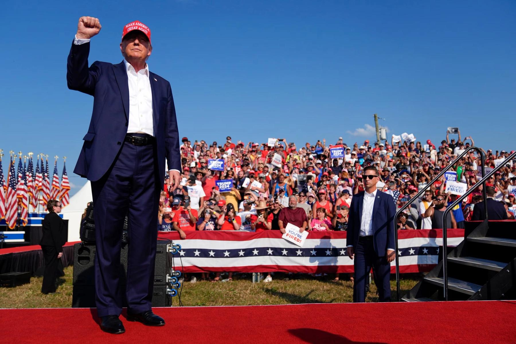 President Donald Trump raising his fist before a crowd