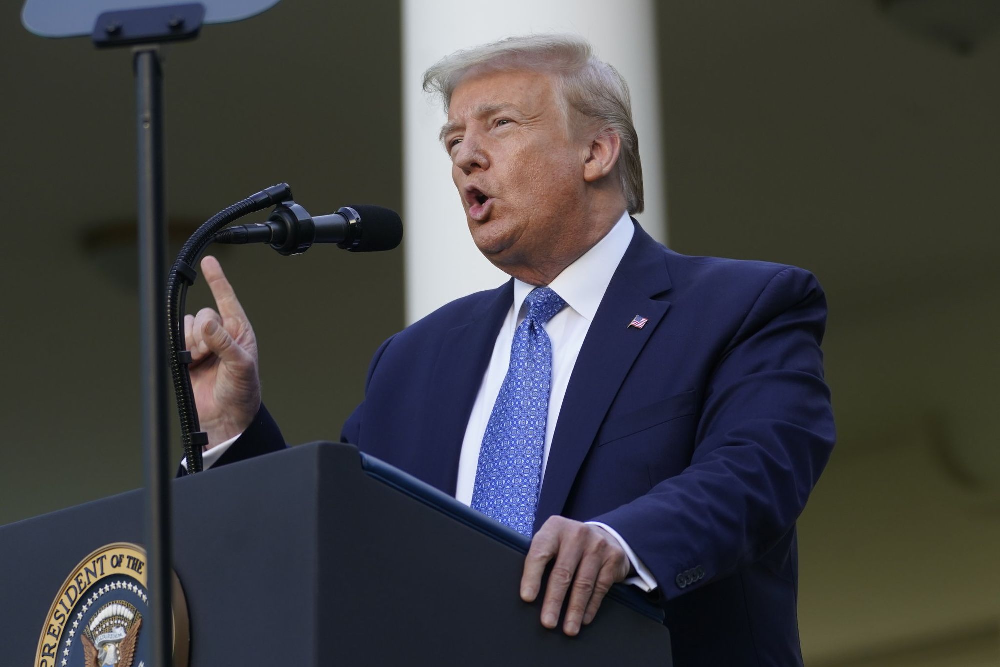 President Donald Trump speaking at a podium