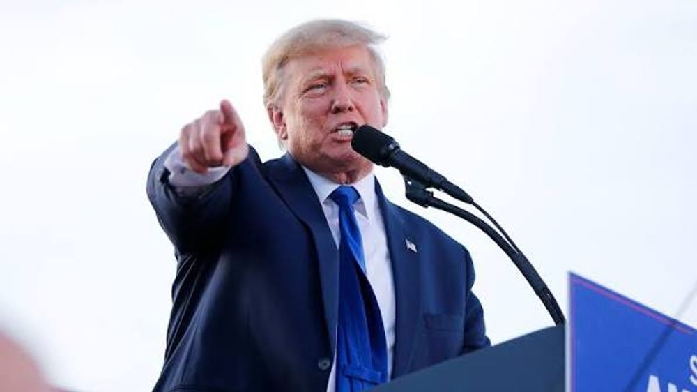 President Donald Trump speaking into a microphone