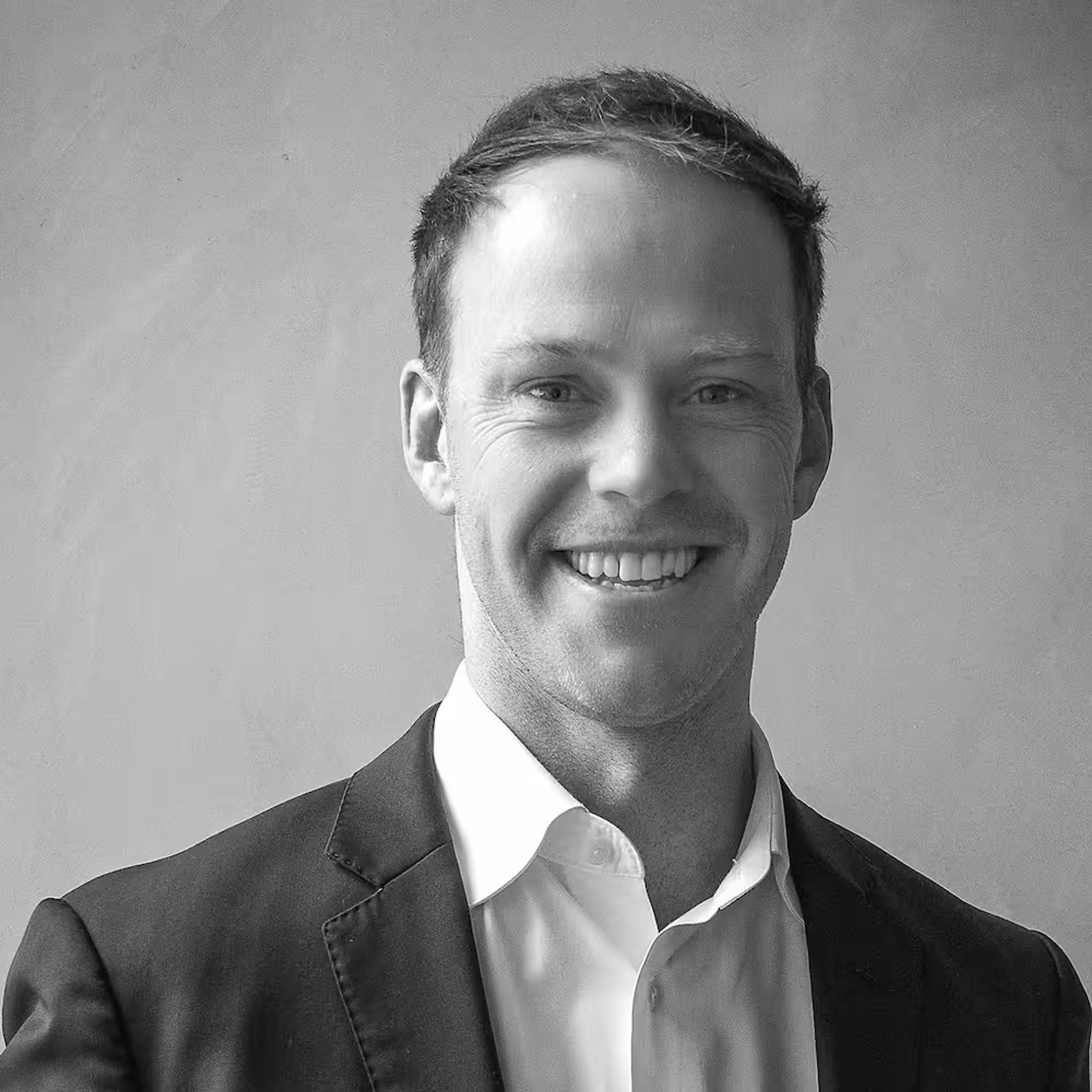 Black-and-white portrait of Josh Caldow, Director at Pinnacl