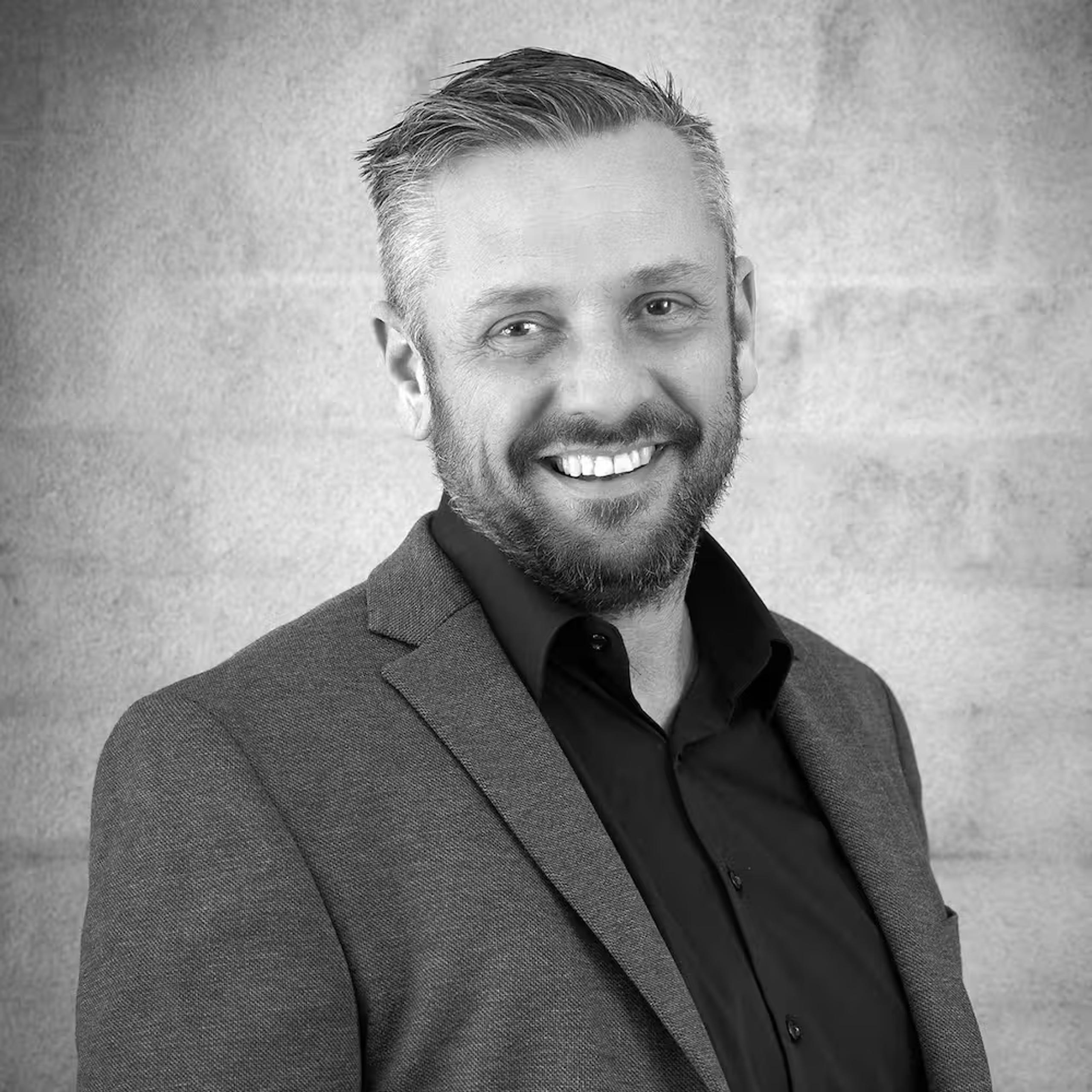 Black-and-white portrait of Ben Jackson, Director at Pinnacl