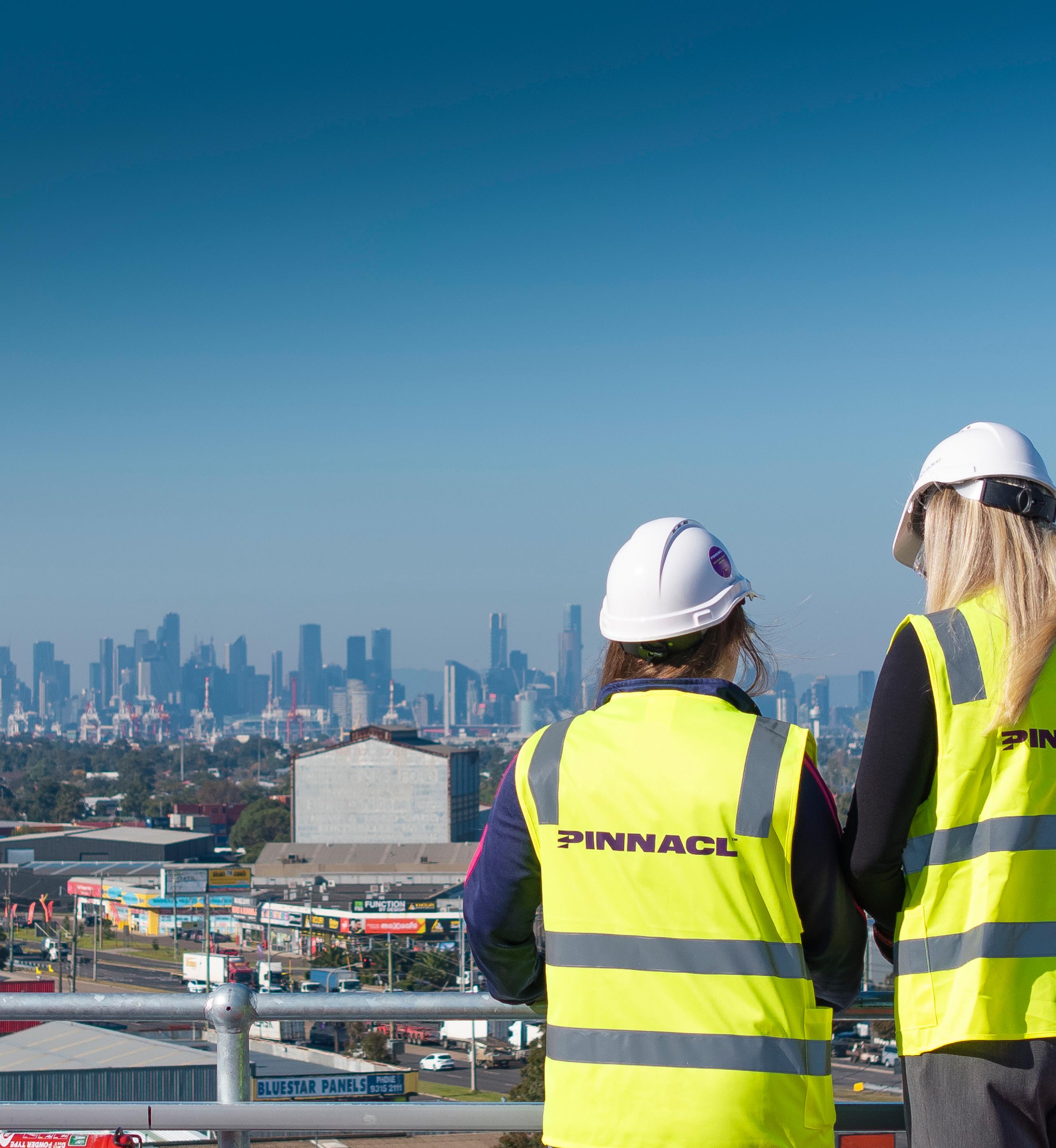 Two construction workers looking over melbourne australia