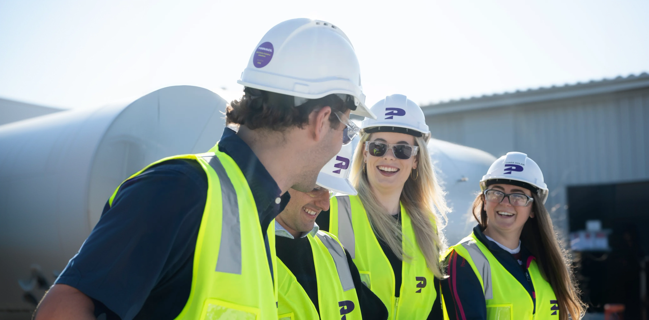 Pinnacl team members in hard hats and hi-vis on a construction site