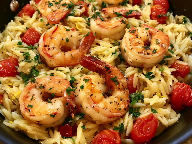 Greek lemon shrimp and orzo tossed together until evenly combined.