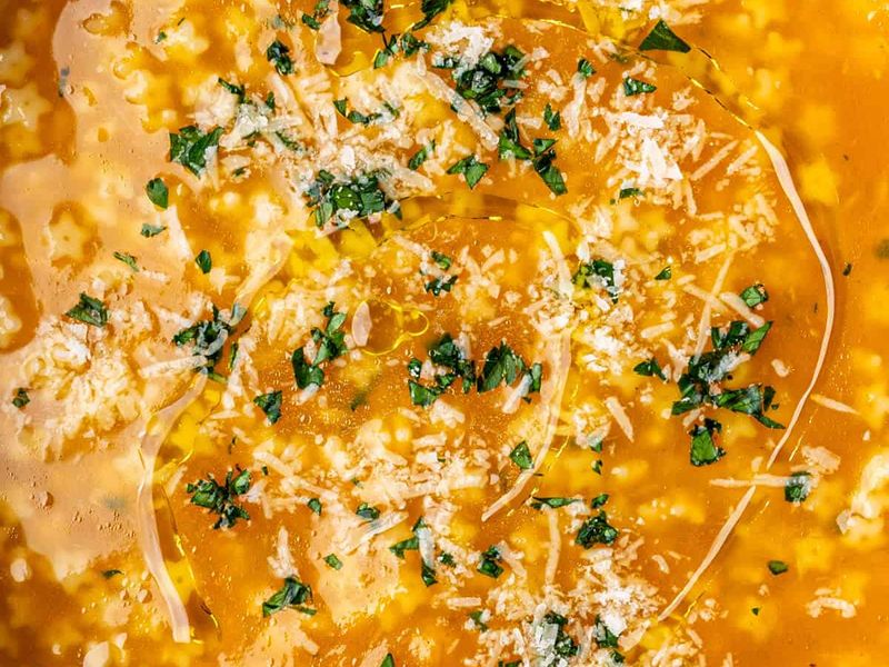 Italian penicillin soup being seasoned served in a bowl