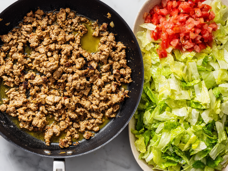 Chopped lettuce divided into two serving bowls as the base.