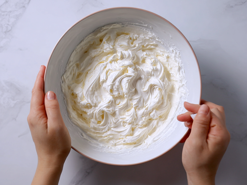 Add Greek yogurt to a bowl and spread it evenly.