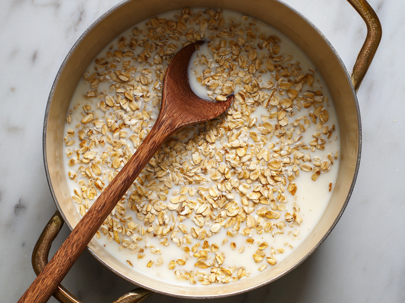 Combine oats and milk in a pot and bring to a gentle simmer.