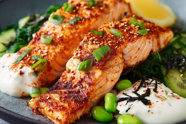 Spicy salmon rice bowl with avocado, cucumber, rice, and creamy sauce