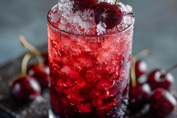 Sleepy girl mocktail in a glass with ice, tart cherry juice, and sparkling water