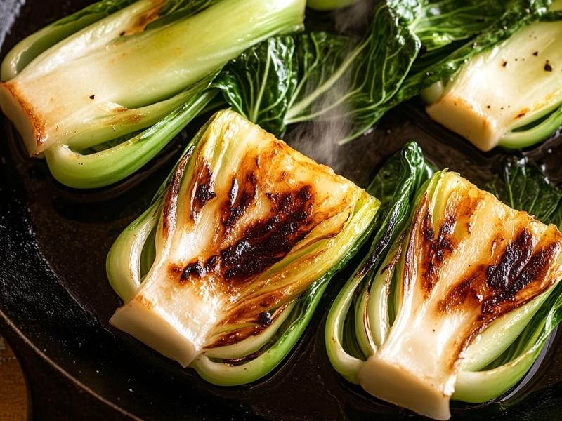 While the cod finishes, sear the bok choy cut-side down in a hot pan until the edges char,