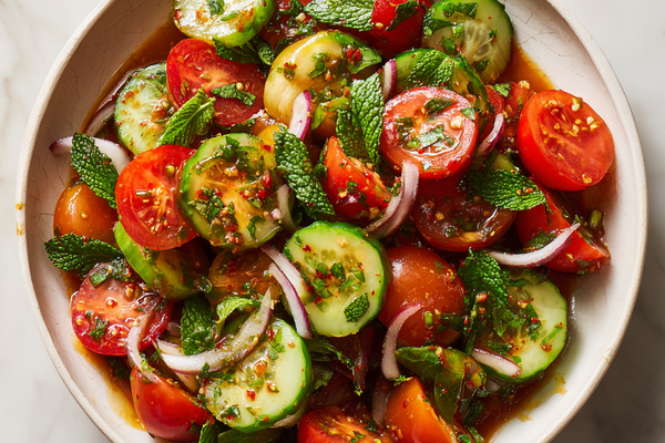 Persian Shirazi cucumber tomato salad with diced cucumbers, tomatoes, red onion, herbs, and lemon dressing in a serving bowl.